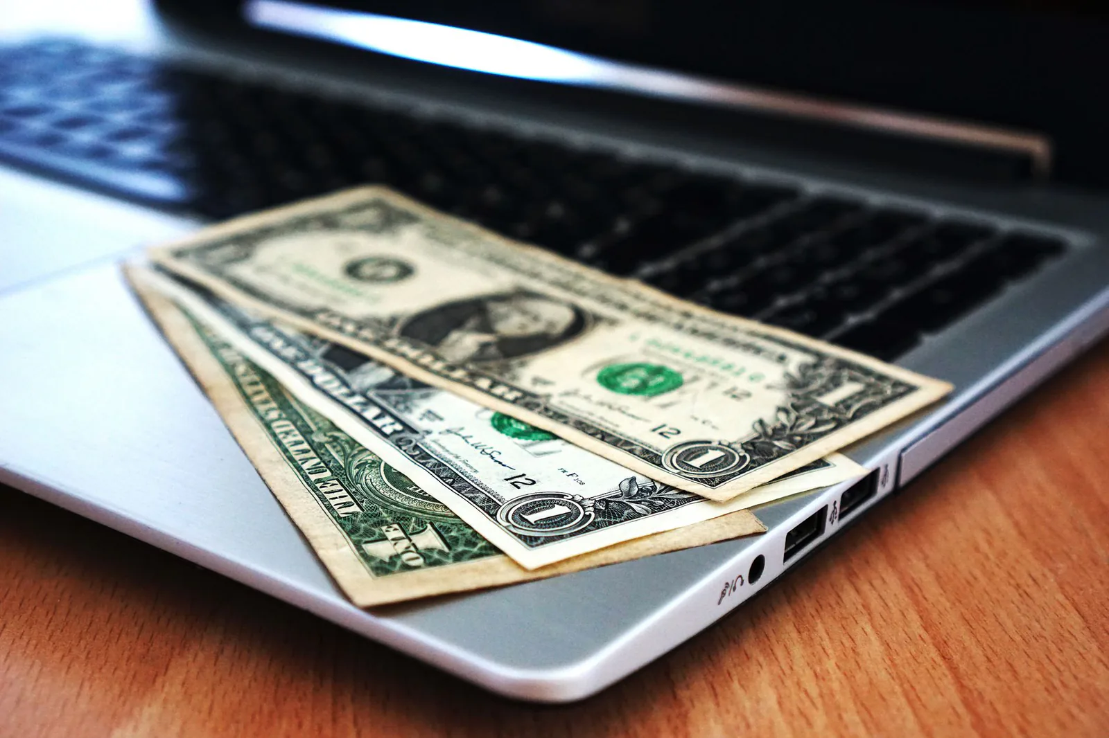 Business banking with laptop and money