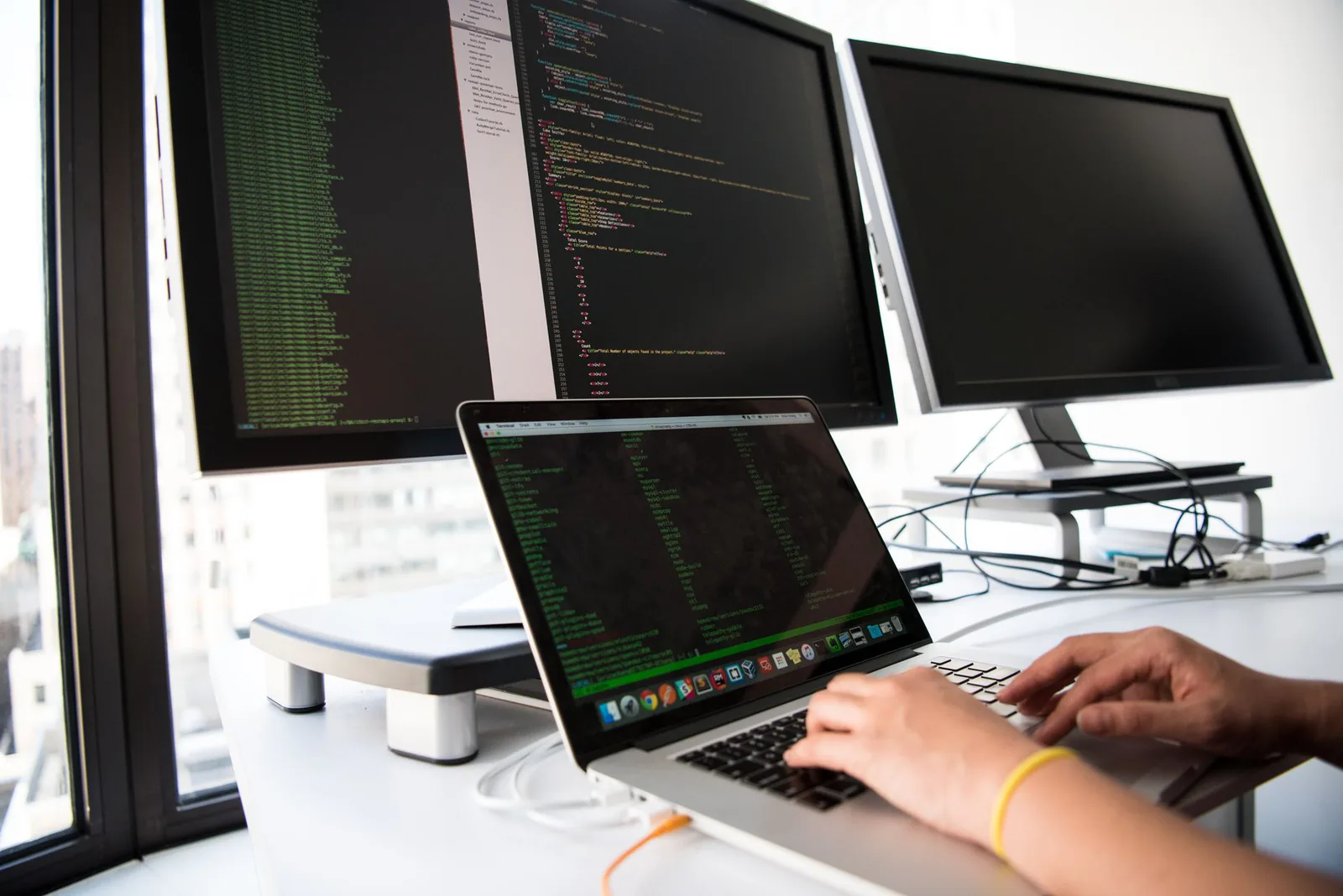 Developer coding on a laptop in a modern workspace
