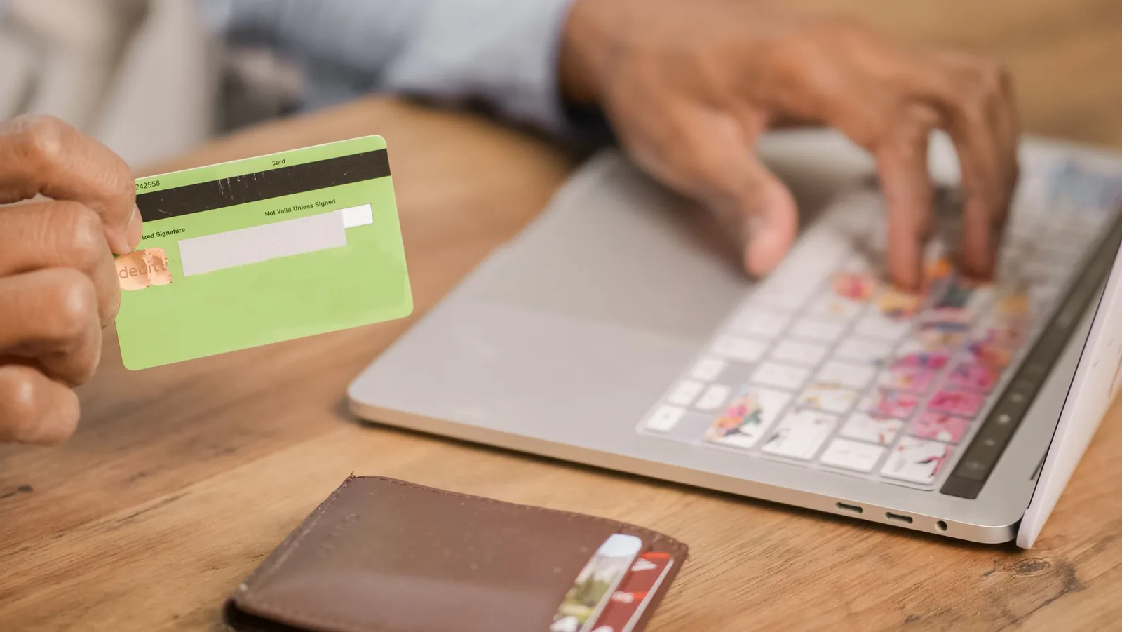 Person using a credit card for an online purchase on a laptop