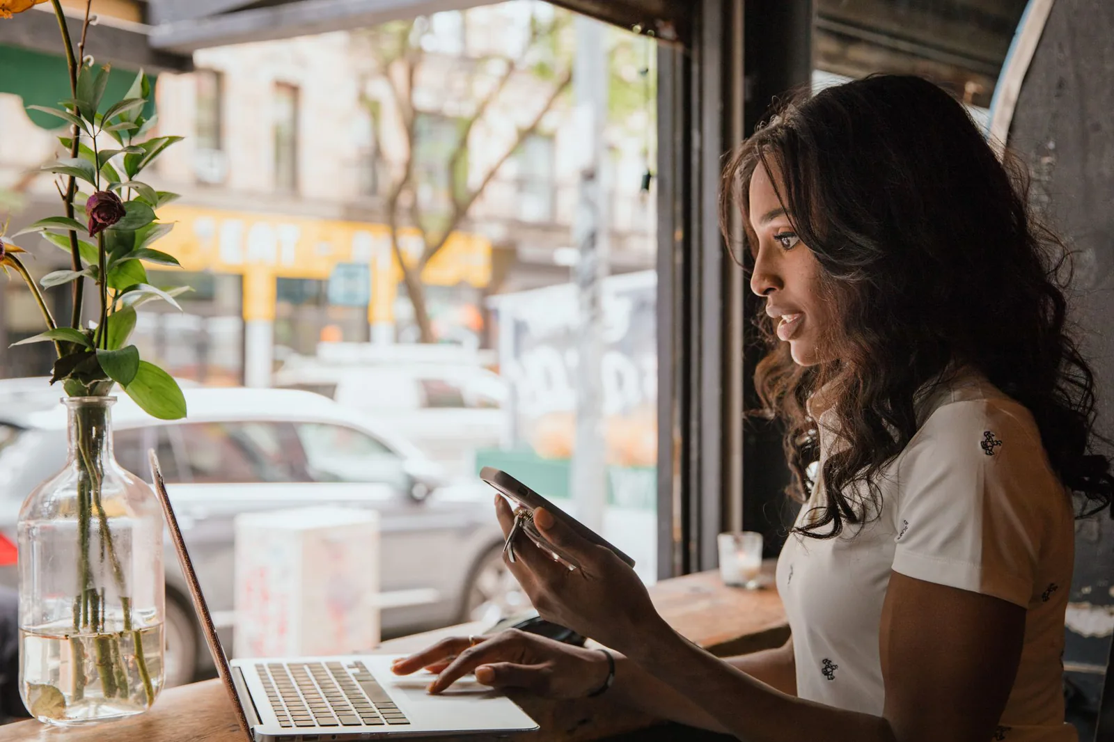 Woman working remotely on a laptop in a cafe