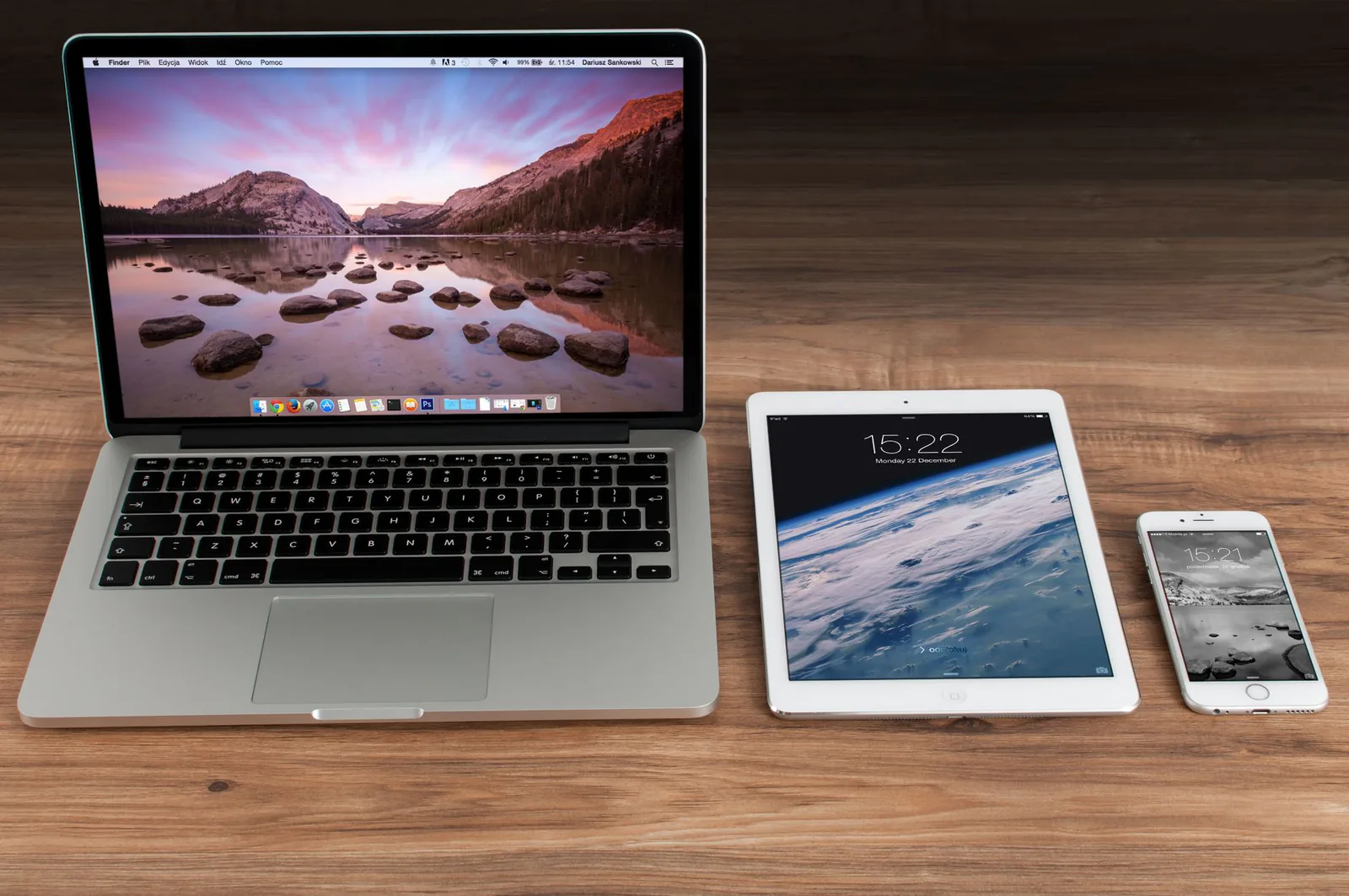 Laptop, tablet, and smartphone on a wooden desk showing responsive design