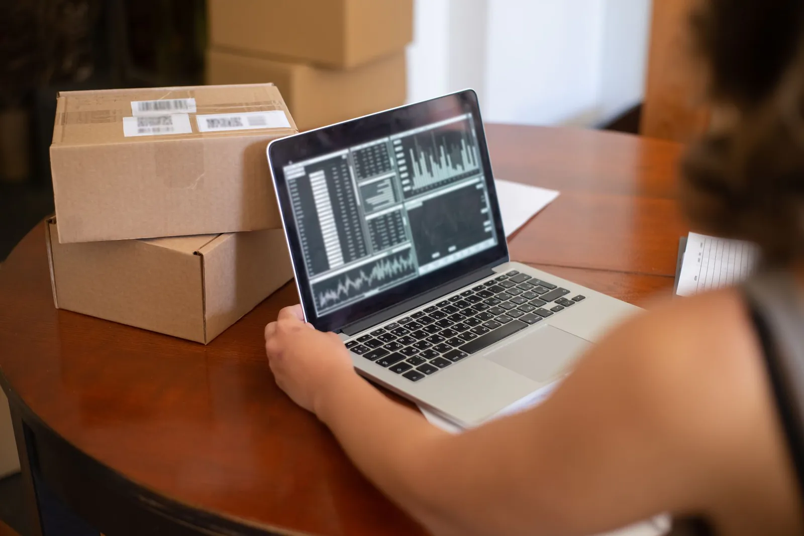 Small business owner managing online store orders on laptop