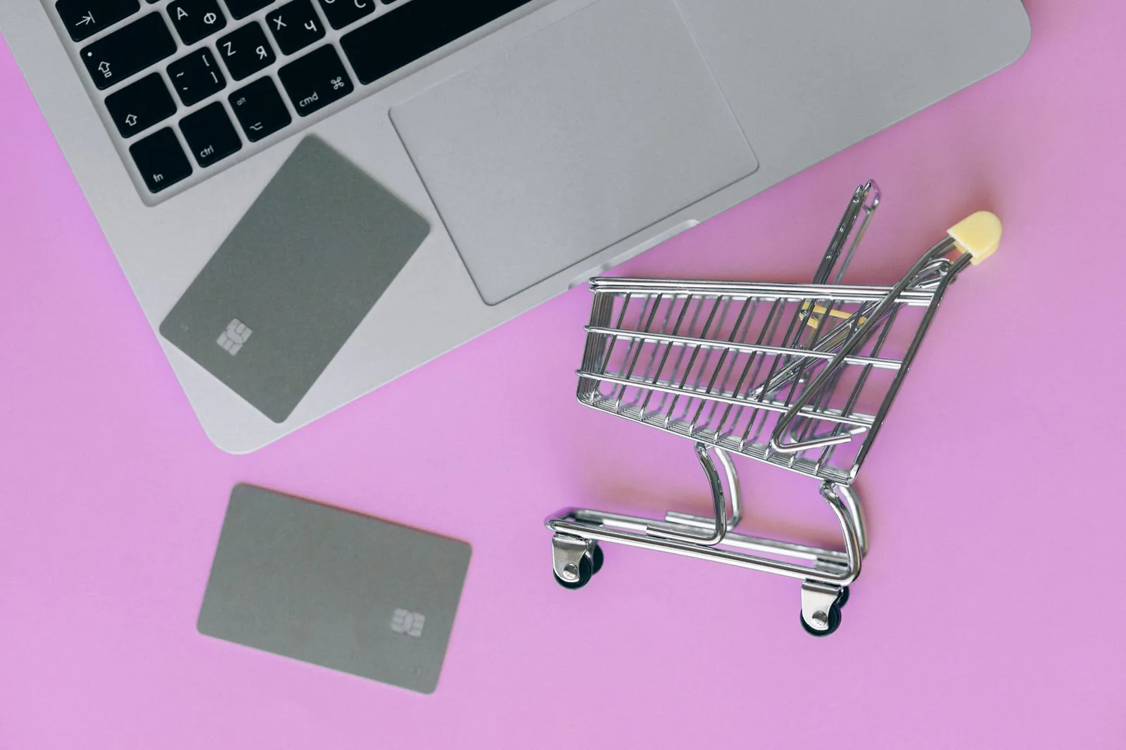 Online shopping cart and credit card on laptop representing ecommerce