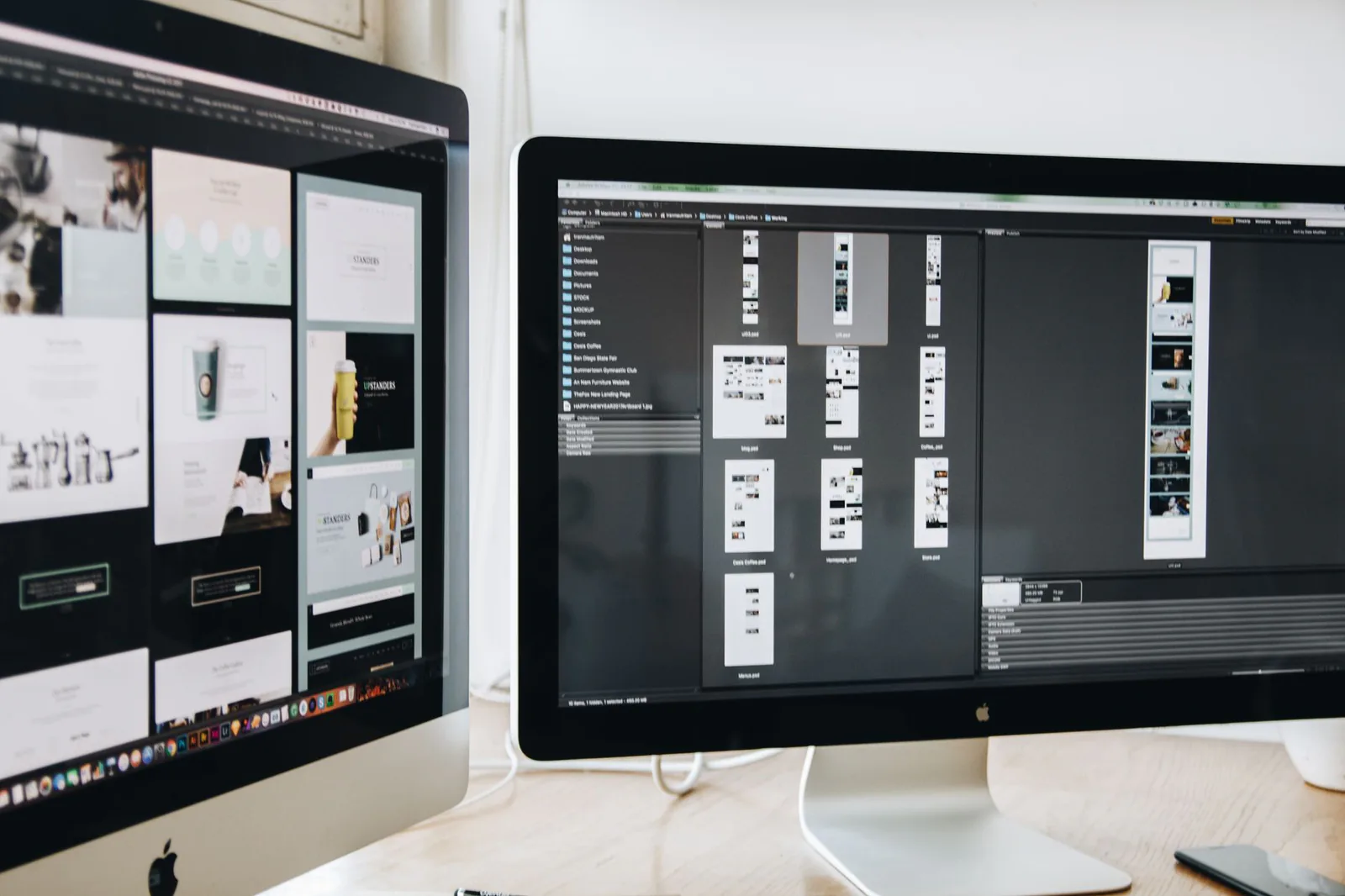 Web design displayed on multiple monitors in a modern workspace